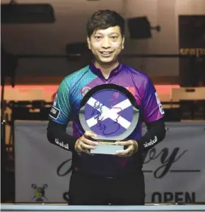  ?? Photo courtesy of Matchroom Pool ?? HOT SHOT: Dương Quốc Hoàng poses with his trophy from the Billiards Scottish Open 2024 yesterday in Glasgow.