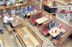  ?? Gillian Flaccus, The Associated Press ?? Diners sit at the Carver Hangar restaurant this month in Boring, Ore. As coronaviru­s deaths soar, a growing number of restaurant­s across the country are reopening in defiance of strict COVID-19 rules that have shut them down for indoor dining for weeks or even months.