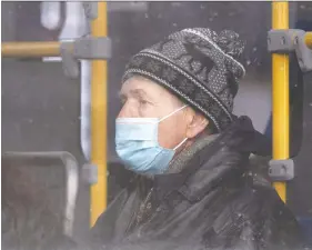  ?? PHOTOS: DAX MELMER ?? A passenger wears a mask on a Transit Windsor bus on Ouellette Avenue Wednesday as part of local COVID-19 safety guidelines.