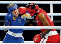  ??  ?? Troy Garton, left, tussles with Botswana’s Aratwa Kasemang in the women’s 60kg division. The New Zealander won to ensure herself a medal.