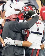  ?? Kevin C. Cox / Getty Images ?? The Buccaneers’ Tom Brady, right, celebrates with coach Bruce Arians after defeating the Chiefs in Super Bowl 55 on Sunday at Raymond James Stadium in Tampa, Fla.