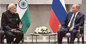  ?? AFP PIC ?? Russian President Vladimir Putin (right) meeting with Indian Prime Minister Narendra Modi in South Africa in July.