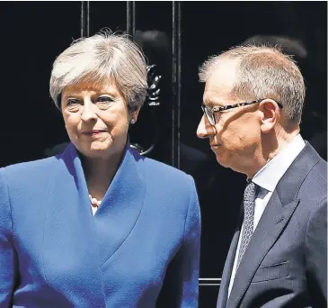  ?? MATT DUNHAM, AP ?? British Prime Minister Theresa May and her husband, Philip, stand Friday at 10 Downing Street in London.