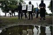  ?? NOAH BERGER- THE ASSOCIATED PRESS ?? Black-clad protesters, gathered to oppose conservati­ve groups staging an “End Domestic Terrorism” rally, hold signs in Portland, Ore., on Saturday.