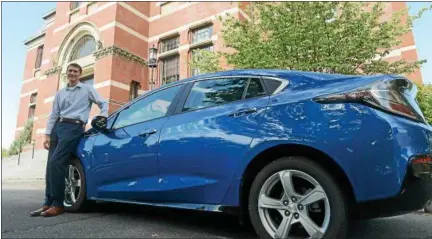  ?? TANIA BARRICKLO — DAILY FREEMAN ?? Kingston Mayor Steve Noble stands next to his own 2016 Chevy Volt, a plug-in electric-hybrid that gets the first 60 miles on electric power before switching to gas.