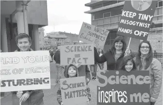  ??  ?? From left: Dante Antinuk, 13; Henry Wignall, 7; Lucas Wignall (face hidden), 12; Angela Wignall; Kiana Antinuk, 9; and Kira Antinuk at the March for Science in Victoria on Saturday.