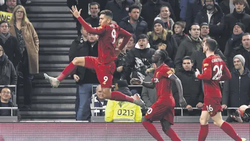  ??  ?? Liverpool players celebrate after scoring the opening goal against Tottenham in London, Jan. 11, 2020.