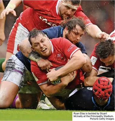  ?? ?? Ryan Elias is tackled by Stuart Mcinally at the Principali­ty Stadium.
Picture: Getty Images