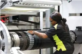  ?? STAFF PHOTO ?? Shikela Ray, a tire building machine operator, works at the Nokian Tyres production plant in Dayton, in 2019. At full production, the plant is expected to produce 4 million tires annually.