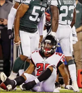  ?? ELSA / GETTY IMAGES ?? Falcons rookie running back Ito Smith is stopped by the Jets’ Terrence Brooks in the first half of Friday’s preseason game in East Rutherford, New Jersey.