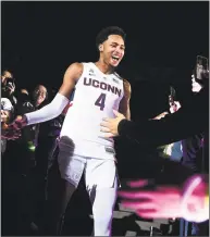  ?? Jessica Hill / Associated Press ?? UConn’s Jalen Adams is greeted by fans as he is introduced during UConn’s men’s and women’s First Night celebratio­n Friday in Storrs.