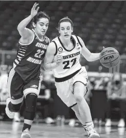  ?? Carmen Mandato / Getty Images ?? Iowa’s Caitlin Clark, right, had 23 points, seven rebounds and seven assists as the Hawkeyes defeated Central Michigan in an NCAA Tournament game on Sunday at the Alamodome.