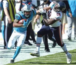  ?? BRIAN WESTERHOLT/AP ?? Panthers running back Trenton Cannon stiff-arms Bears linebacker Roquan Smith, who finished with a team-high 12 tackles Sunday.