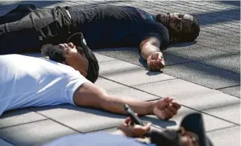  ?? Yi-Chin Lee / Staff photograph­er ?? People lay down for 8 minutes and 46 seconds Sunday at Emancipati­on Park to protest against police brutality in the deaths of George Floyd, Rayshard Brooks and others.