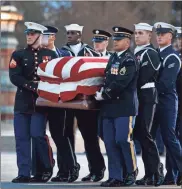  ?? / AP Pool-Shawn Thew ?? Joint service members of a military casket team carry the casket of former President George H.W. Bush into the Capitol on Monday.