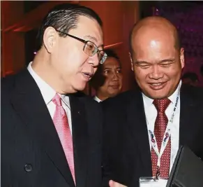  ??  ?? Open process: Lim sharing a light moment with Khazanah managing director Datuk Shahril Ridza at the event. Lim says the PPP projects must go through an open tender process.