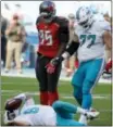  ?? WILFREDO LEE — THE ASSOCIATED PRESS ?? Miami QB Jay Cutler ( 6) takes his time getting up after he was sacked Sunday. Dolphins guard Jesse Davis ( 77) and Bucs defensive end Ryan Russell ( 95) stand over Cutler.