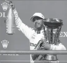  ?? DARRON CUMMINGS, THE ASSOCIATED PRESS ?? Mercedes driver Lewis Hamilton of Britain celebrates after winning the U.S. Grand Prix auto race at the Circuit of the Americas in Austin, Texas.