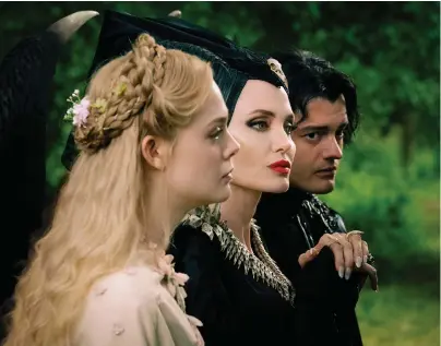  ?? Jaap Buitendijk/Walt Disney Motion Pictures ?? From left, Elle Fanning, Angelina Jolie and Sam Riley in “Maleficent: Mistress of Evil.”