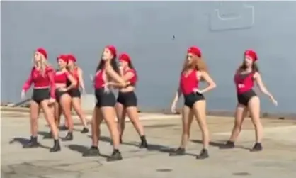  ?? Photograph: @alexbruces­mith/Twitter ?? 101 Doll Squadron dancers perform at the launch of the Australian navy ship HMAS Supply in Sydney. They say they feel ‘unsafe’ after the ABC video of their twerking routine went viral.