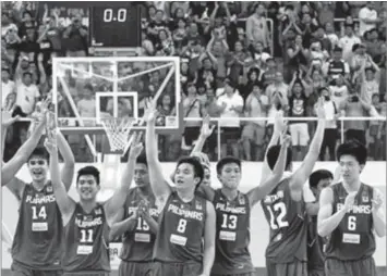  ?? FIBA ASIA PHOTO ?? Batang Gilas waves to a jubilant Filipino crowd in the Al-Gharafa Sports Club hall after downing the host team in an epic comeback 82-79 win in Doha, Qatar.