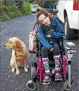 ?? SUBMITTED PHOTO ?? Emma White, 9, with her companion, Lovisa, a Golden Retriever and labrador mix, who has helped the Manoa Elementary School student work through the restrictio­ns from living with cerebral palsy that has often make communicat­ion with her peers difficult.