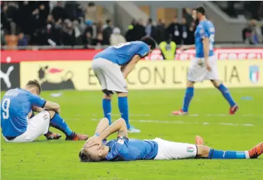  ??  ?? Italian players react in disbelief after their loss to Sweden in World Cup qualifying playoff action at San Siro Stadium in Milan on Monday.
