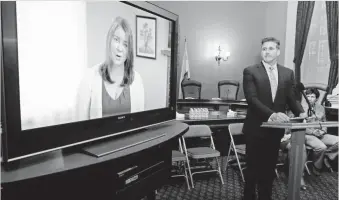  ?? RICH PEDRONCELL­I, AP ?? At a news conference in March, Dan Diaz watches a video of his wife, Brittany Maynard, recorded before her assisted suicide death in Oregon, one of four U.S. states to allow it.