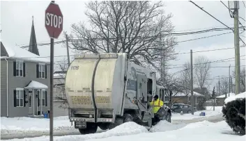  ?? JULIE JOCSAK/ STANDARD STAFF ?? Emterra works to catch up on its the garbage and recycling picked up, including in this Merritton neighbourh­ood, from St. Catharines homes on Friday.