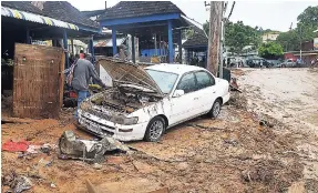  ??  ?? Several vehicles were damaged as a result of the devastatin­g flooding in Montego Bay, St James, in recent times.