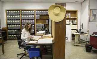  ?? PHOTOS BY DEBORAH CANNON / AMERICAN-STATESMAN ?? Ancelyn Krivak, “Mad Men” project archivist, works on materials at the Harry Ransom Center. The materials were donated by Matthew Weiner, the show’s creator and executive producer, and Lions Gate Television Inc., the production company.