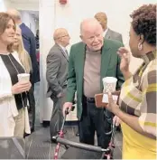  ?? JERRY FALLSTROM/ORLANDO SENTINEL ?? Porshialee Byfield, principal of the Lake Success Academy, right, speaks Tuesday with Lake County school Superinten­dent Diane Kornegay, from left, and Steve Tibbits, 77, of Altoona.