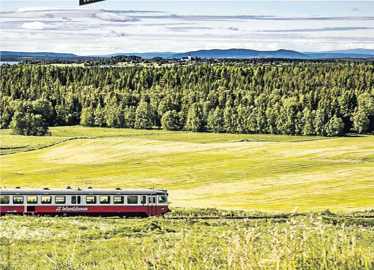  ?? Picture: © Håkan Wike ?? SLOW TRAIN COMING One of the railcars used on Sweden’s privately operated, summer-only Inland Line railway ambles through the bucolic countrysid­e as it heads north towards the Arctic Circle.