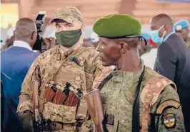  ?? ?? A private security guard from Russia’s Wagner Group, left, stands next to a Central African Republic soldier during a rally March 18 in the capital city of Bangui.