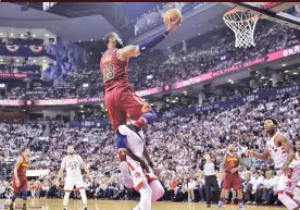  ??  ?? FRANK GUNN/AP Cavaliers forward Lebron James (top) shoots against the Raptors during Game 2 of an NBA basketball playoffs second-round series in Toronto’s Air Canada Centre on May 3, 2018.