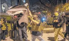  ?? VICTORJ.BLUE/THE NEWYORKTIM­ES ?? A BLM banner is torn Saturday from Asbury United Methodist Church in Washington.