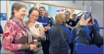  ?? MARLA BROSE/JOURNAL ?? Irina Tiukhtyaev, left, and daughter Margarita Shmidt, enjoy a congratula­tory glass of sparkling wine at the Two Eagles mission control center Saturday morning.