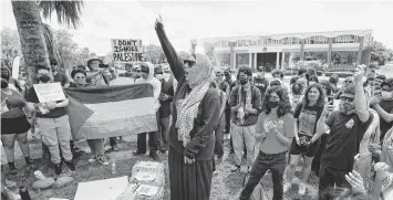  ?? JOE BURBANK Orlando Sentinel/TNS ?? A pro-Palestinia­n crowd cheers speaker Reem Elkhaldi at a rally at the University of Central Florida in Orlando on Friday in support of Palestinia­ns. About 200 people rallied in opposition to Israel’s war against Hamas in Gaza.