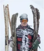  ?? GE / XINHUA ZHAO WEI HAI / XINHUA ?? A visitor from Guangzhou in Guangdong province skis with the traditiona­l skis and wooden pole in Hemu village. A Kazak rider performs a horseback stunt at the opening ceremony of an ice and snow tourism festival held in Zhaosu, Ili Kazak autonomous...