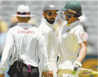  ??  ?? India’s Test captain Virat Kohli faces off with his Australian counterpar­t, Tim Paine.