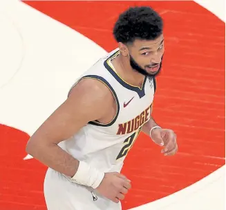  ?? Kevin C. Cox, Getty Images ?? Denver’s Jamal Murray reacts against the Atlanta Hawks during the second half at State Farm Arena on Sunday in Atlanta.