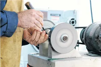  ?? ROBERT MAXWELL ?? A furnace blower motor and a couple of buffing wheels on a homemade wooden base is the system Steve Maxwell uses to sharpen woodworkin­g tools.