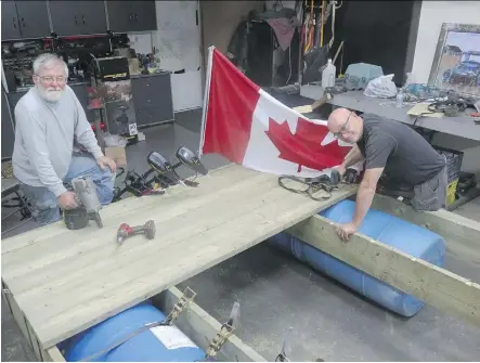  ?? NICK LEES ?? Roger Kehoe, left, and Gordon Lair spent 12 hours over the weekend building a raft. They hope to return the Sourdough Raft Race on the North Saskatchew­an River to its former glory when as many as 200 rafts took part and thousands lined the banks to...