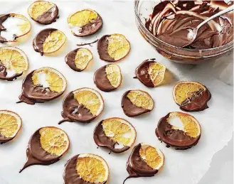  ?? [PHOTO BY TOM MCCORKLE, FOR THE WASHINGTON POST] ?? Chocolate-Dipped Orange Crisps