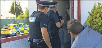  ??  ?? Police carrying out the raid at an address in Ashford