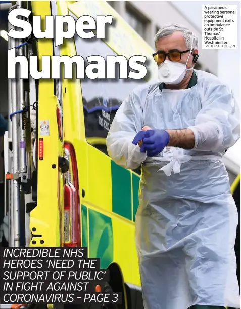  ?? VICTORIA JONES/PA ?? A paramedic wearing personal protective equipment exits an ambulance outside St Thomas’ Hospital in Westminste­r