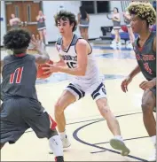  ?? / Scott Herpst ?? Gordon Lee’s Justin Wooden looks for a passing lane as Mt. Zion’s Andrew Powell (11) and Tyrese Farley (4) during the Region 6- A tournament at Trion last week.