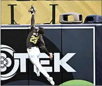  ?? DENIS POROY / AP ?? San Diego Padres right fielder Fernando Tatis Jr. makes a leaping catch on a ball hit by Seattle’s Jorge Polanco during Monday’s exhibition game in San Diego.