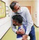  ?? ?? Pediatric cardiologi­st Dr. Avichal Aggarwal hugs Kingston, who got to go home just in time for Christmas.