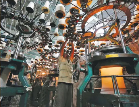  ?? (Rupak De Chowdhuri/Reuters) ?? AN EMPLOYEE works inside an undergarme­nt factory in Kolkata, India, yesterday. Entering 2017, global economic growth gathered momentum, according to surveys released yesterday, continuing the trend from last year thanks to a bounce in consumptio­n.